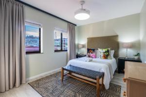 a hotel room with a bed and a window at Rosebud 4 Beacon Point in Mossel Bay