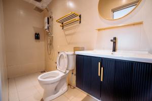 a bathroom with a toilet and a sink at The Marion Hotel Impian Emas Branch in Skudai