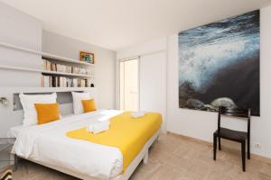 a bedroom with a large bed with towels on it at Mer du Sud 4 YourHostHelper in Cannes
