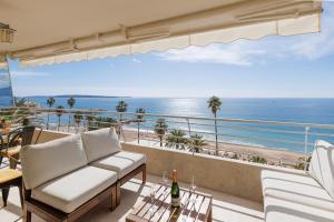 a living room with a view of the ocean at Mer du Sud 4 YourHostHelper in Cannes