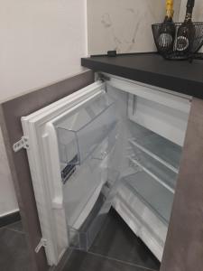 an empty refrigerator with its door open in a kitchen at LuX Apartments in Lugo