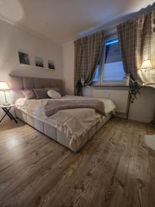 a bedroom with a large bed and a window at Blick zur Burg in Nörten-Hardenberg