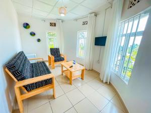 a living room with two chairs and a table at Musanto Hotel in Gisenyi