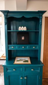 a blue hutch with a picture on it at Hidden Acres- Room with Double & Single Bed, Malahide in Malahide
