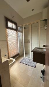 a bathroom with a shower and a sink and a tub at Silver Oak Mansion in Jalandhar