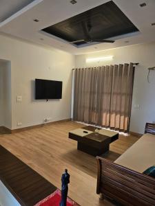 a large room with a flat screen tv on the wall at Silver Oak Mansion in Jalandhar
