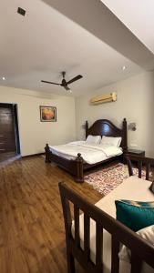 a bedroom with two beds and a ceiling fan at Silver Oak Mansion in Jalandhar