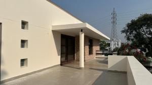 a large white building with a porch at Silver Oak Mansion in Jalandhar