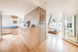 a kitchen with a large wooden cabinet in a room at Apartmán VALORI - 100m2 in Poděbrady