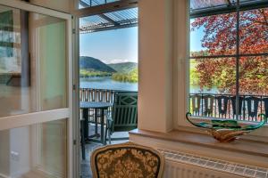 a room with a window with a view of a river at Romantisches Hotel zur Post in Brodenbach