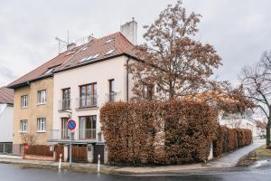 a building with a large bush in front of it at Apartmán VALORI - 100m2 in Poděbrady