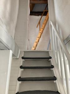 a set of stairs in a room with a stair case at La Modestine in Lanuéjols
