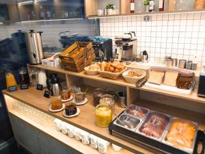 a kitchen with a counter with bread and pastries at Hotel Orion in Budapest