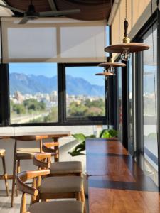 a dining room with tables and chairs and a large window at 吾庭文旅電梯民宿 WuTing Stay in Hualien City