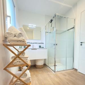 a bathroom with a sink and a glass shower at Villa Saint Mart-Tout Inclus-Plage à 7 min à pied in Saint Martin de Brehal +66 photos
