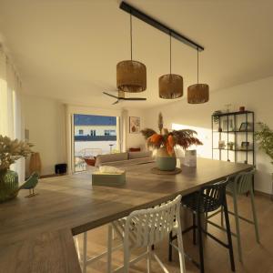 a living room with a large wooden table and chairs at Villa Saint Mart-Tout Inclus-Plage à 7 min à pied in Saint Martin de Brehal