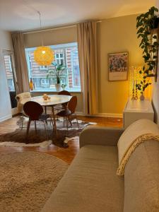 a living room with a couch and a table at Vejle Liv in Vejle