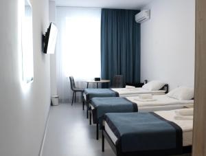 En eller flere senge i et værelse på Impuls Prof Hotel