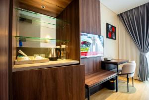 a kitchen with a counter and a table and a chair at Hotel George in Cebu City