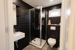 a bathroom with a shower and a toilet and a sink at Yart in Scharendijke +18 photos