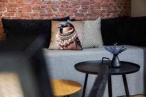 a couch with a pillow on it with a table at Yart in Scharendijke