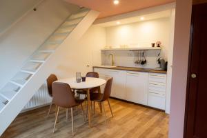 a kitchen and dining room with a table and chairs at Yart in Scharendijke