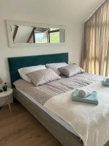 a bedroom with a large bed with a mirror at Villa BELEVITA odmor u prirodi sa grijanim bazenom in Čepelovac +55 photos