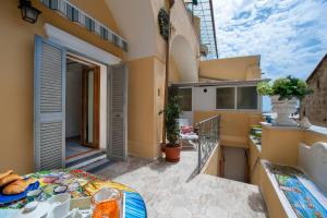 a balcony of a house with a table at Casa Sery in Positano