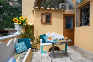 a patio with a table and a chair on a porch at Casa Sery in Positano