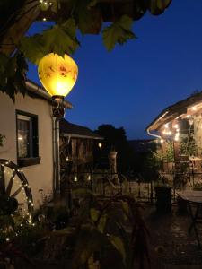 a lantern in the yard of a house at night at Ferienwohnung Sternenzauber in Bad Münstereifel