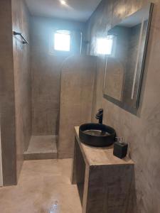 a bathroom with a sink and a shower at Puerto Serifos in Livadi