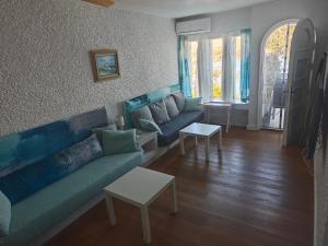 a living room with a couch and a table at The sea-cave house in Puerto de Mazarrón