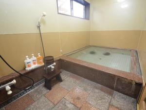 a bath tub with a shower in a bathroom at umashiyado ryoutei minoshima in Kaino +32 photos