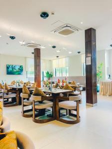 a restaurant with tables and chairs in a room at Zabibu Hotel in Dodoma