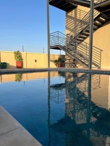 a swimming pool with a stairway in a building at Zabibu Hotel in Dodoma