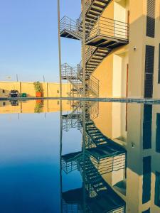 a reflection of a ladder in a pool of water at Zabibu Hotel in Dodoma