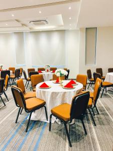 a conference room with two tables and chairs at Zabibu Hotel in Dodoma +158 photos