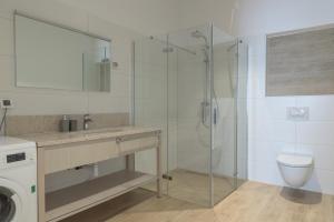 a bathroom with a shower and a sink and a toilet at Mobile Homes Camping Biograd in Biograd na Moru +111 photos