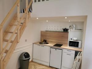 a small kitchen with a sink and a microwave at RUFFEC 14 1D in Ruffec