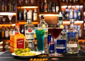 a table with bottles of alcohol and a plate of fruit at Ramadia Ran Mal Holiday Resort in Moratuwa