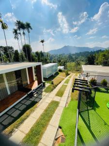 a view of a house with a bench in the yard at West wind Resort in Meppādi
