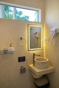 a bathroom with a sink and a mirror and a window at Kalija in General Luna +17 photos