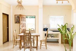 a kitchen and dining room with a table and chairs at Kalija in General Luna