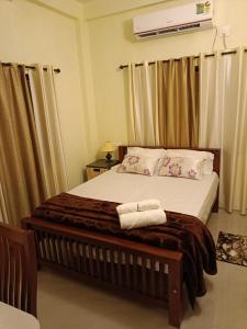 a bedroom with a large bed in a room at Godiva Homestay in Cochin