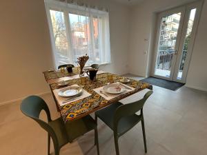 a dining room table with two chairs and a table and chairsktop at Casa Armadillo Guest Rooms in Trento