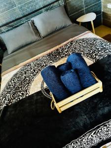a bed with a basket of blue pillows on it at DiMarS in Megara