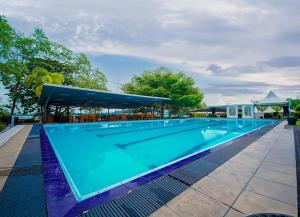 a large blue swimming pool with a canopy at Ramadia Ran Mal Holiday Resort in Moratuwa +46 photos
