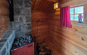 a room with a fireplace in a log cabin at Gorgeous Home In Flatdal With Sauna in Flatdal