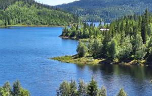 an island in the middle of a body of water at Gorgeous Home In Flatdal With Sauna in Flatdal +27 photos