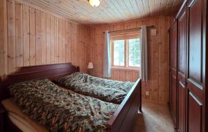 a bedroom with a bed in a wooden room at Gorgeous Home In Flatdal With Sauna in Flatdal